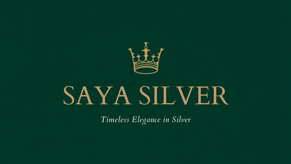 A dark green square graphic with a gold crown icon above the words 'SAYA SILVER' and the tagline 'Timeless Elegance in Silver'.